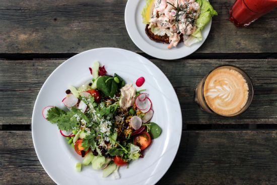 Salad besides cup of coffee