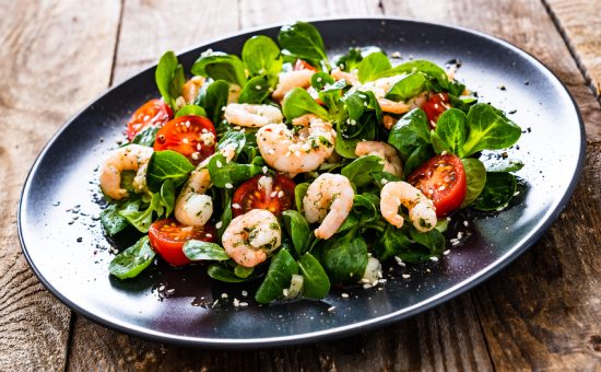 Prawn salad on wooden table