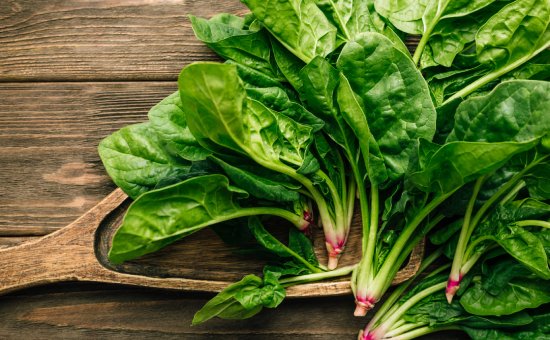 Fresh spinach on wooden background